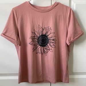 Women’s pink t-shirt with a flower on it. It’s from Shein and a size medium.
